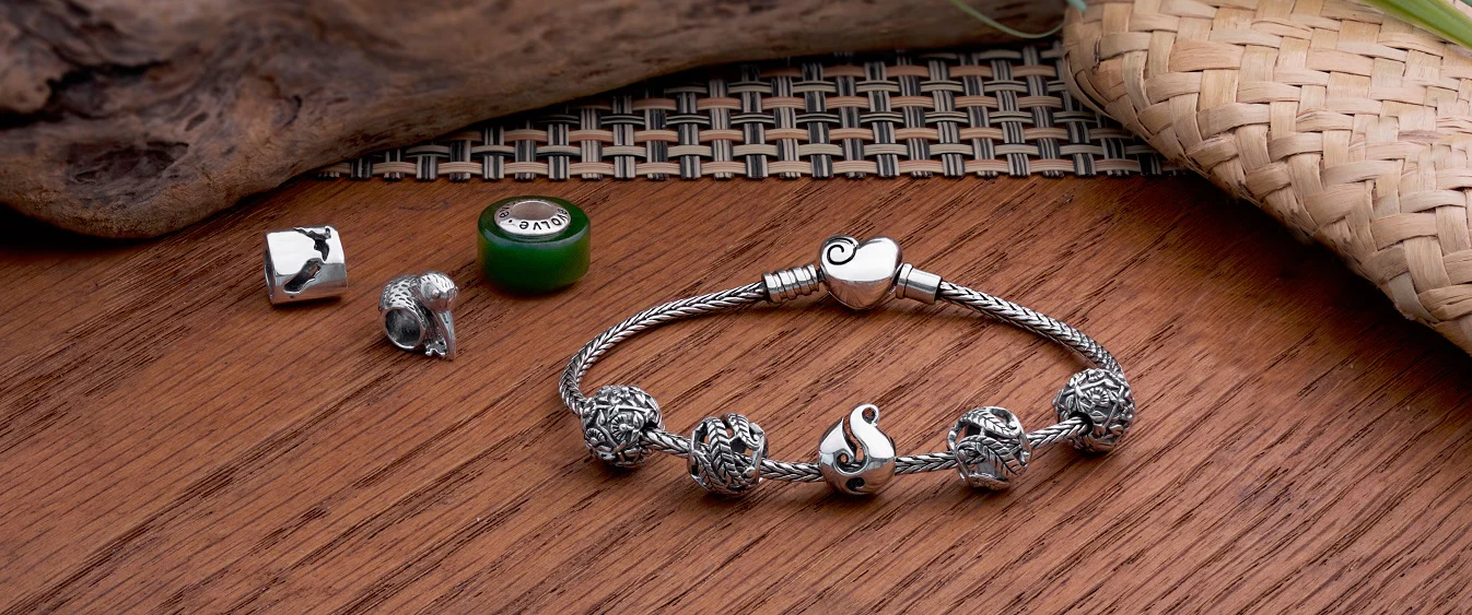 A range New Zealand EVOLVE charms on bracelet